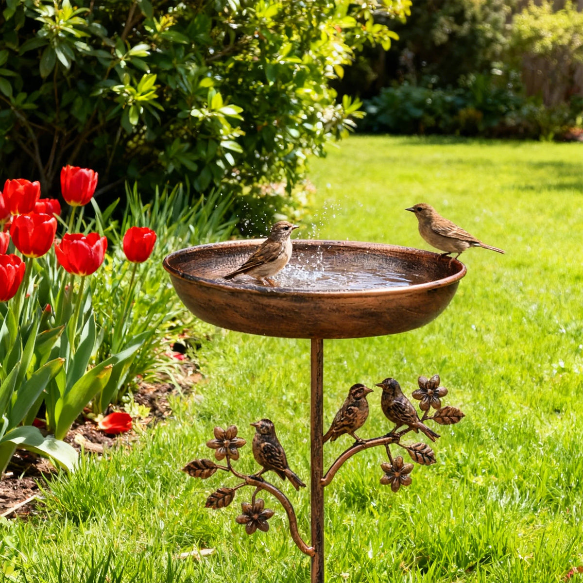 The bird bath showing its bowl, stake and decorative bird detailing